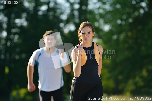 Image of Young couple jogging