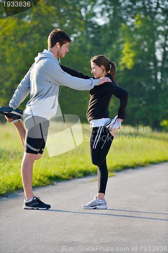 Image of Couple doing stretching exercise  after jogging