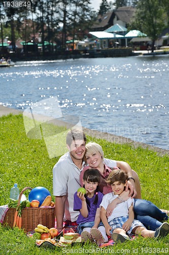 Image of Happy family playing together in a picnic outdoors
