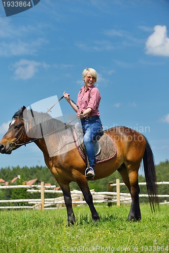 Image of happy woman  on  horse