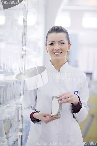 Image of pharmacist chemist woman standing in pharmacy drugstore