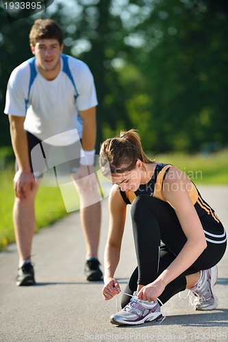 Image of Couple doing stretching exercise  after jogging