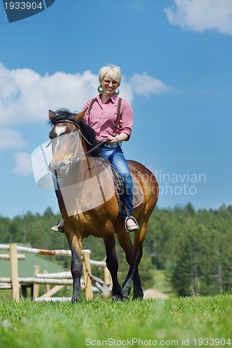 Image of happy woman  on  horse