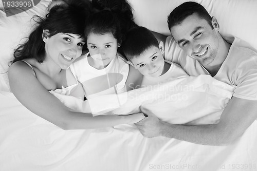 Image of happy young Family in their bedroom