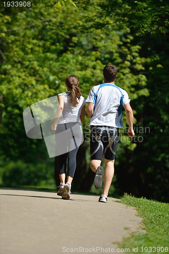 Image of Young couple jogging at morning