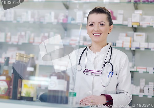 Image of pharmacist chemist woman standing in pharmacy drugstore