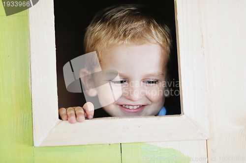Image of happy child in a window