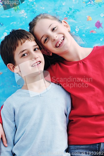 Image of portrait of happy brother and sister at home
