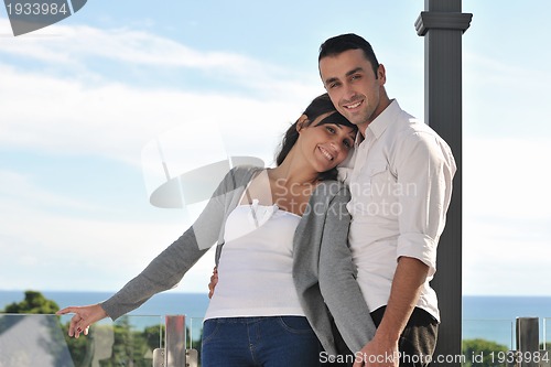 Image of couple relaxing on balcony