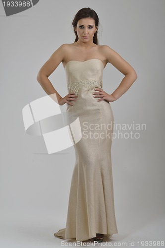 Image of elegant woman in fashionable dress posing in the studio