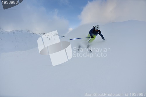 Image of skiing on fresh snow at winter season at beautiful sunny day