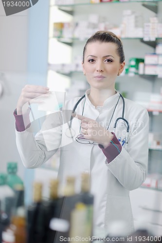 Image of pharmacist chemist woman standing in pharmacy drugstore