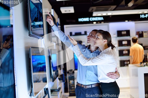 Image of Young couple in consumer electronics store