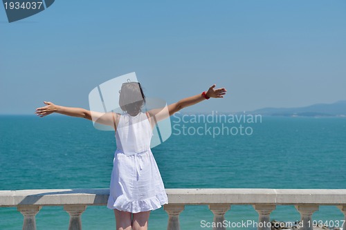 Image of happy young woman with spreading arms to sky
