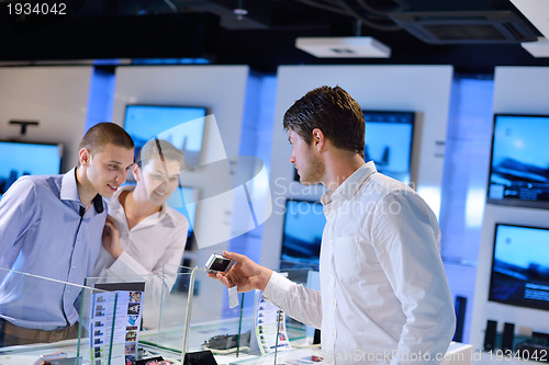 Image of Young couple in consumer electronics store