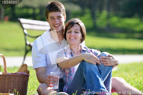 Image of happy young couple having a picnic outdoor