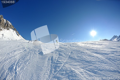 Image of skiing on fresh snow at winter season at beautiful sunny day