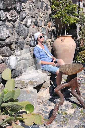 Image of Greek woman on the streets of Oia, Santorini, Greece