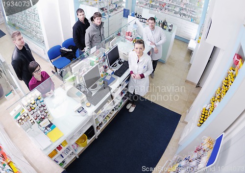 Image of pharmacist suggesting medical drug to buyer in pharmacy drugstor