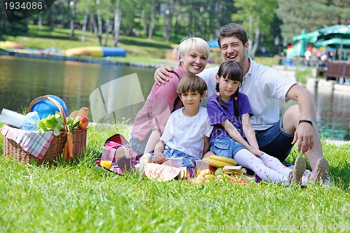 Image of Happy family playing together in a picnic outdoors