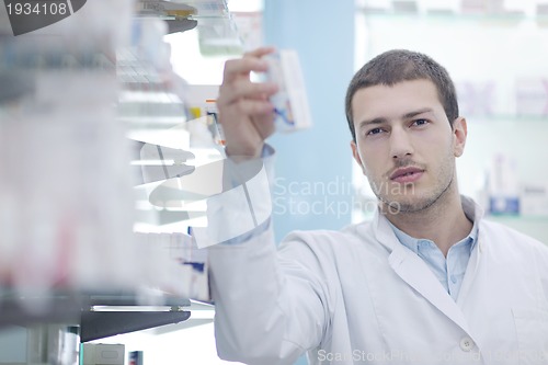 Image of pharmacist chemist man in pharmacy drugstore