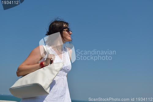 Image of young woman with spreading arms to sky