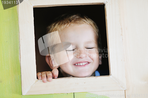 Image of happy child in a window