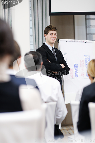 Image of Young  business man giving a presentation on conference