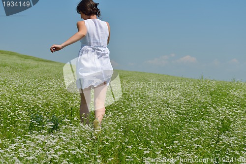 Image of Young happy woman in green field