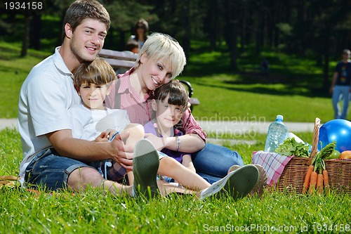Image of Happy family playing together in a picnic outdoors