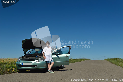 Image of woman with broken car