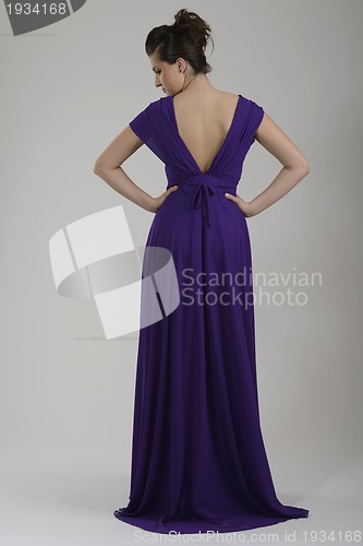 Image of elegant woman in fashionable dress posing in the studio