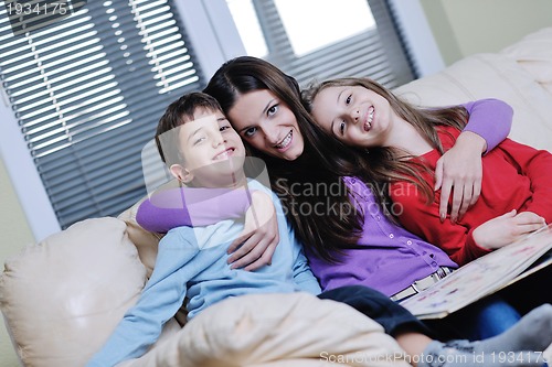 Image of young mom play with their kids at home and reading book