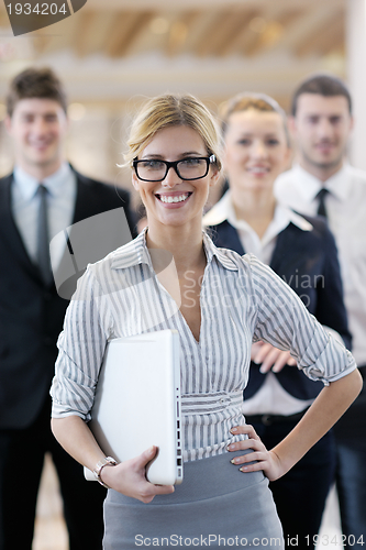 Image of business woman standing with her staff at conference
