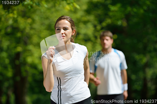 Image of Young couple jogging at morning