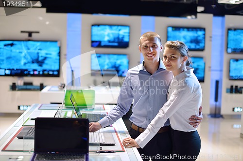 Image of Young couple in consumer electronics store