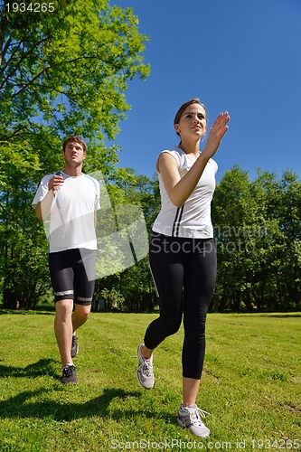 Image of Young couple jogging at morning