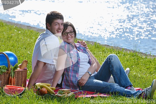 Image of happy young couple having a picnic outdoor