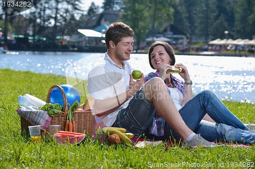 Image of happy young couple having a picnic outdoor