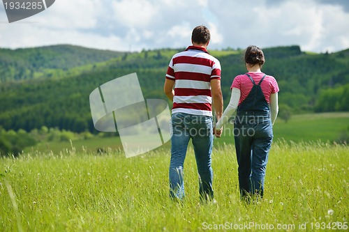 Image of Portrait of romantic young couple smiling together outdoor