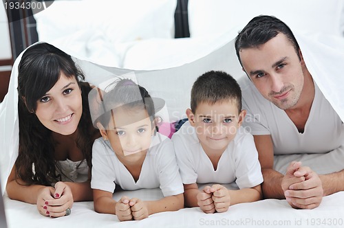 Image of happy young Family in their bedroom