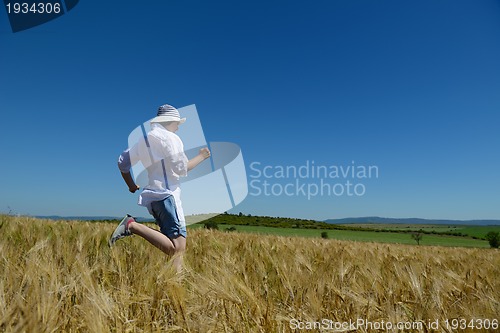 Image of young woman in wheat field at summer