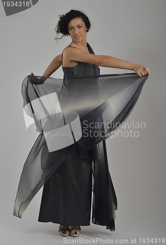 Image of elegant woman in fashionable dress posing in the studio