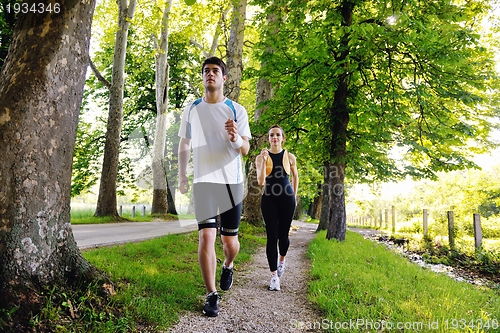 Image of Young couple jogging