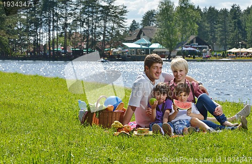 Image of Happy family playing together in a picnic outdoors