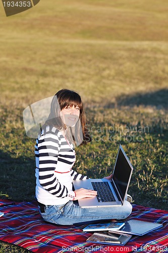 Image of young teen girl work on laptop outdoor