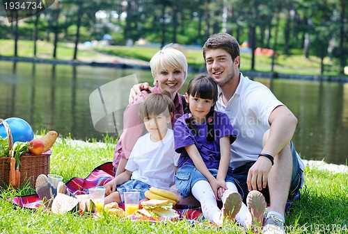 Image of Happy family playing together in a picnic outdoors