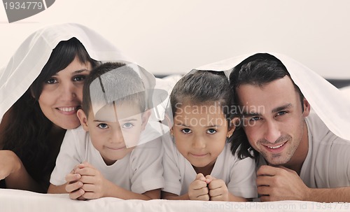 Image of happy young Family in their bedroom