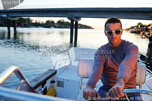 Image of portrait of happy young man on boat