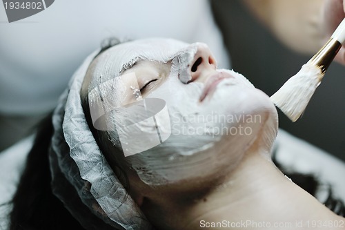 Image of woman with facial mask in cosmetic studio